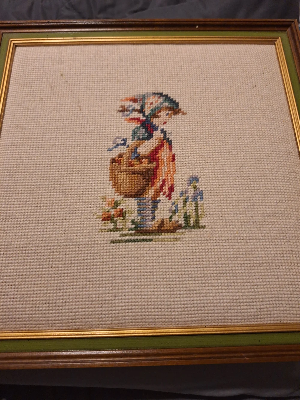 a pair of vintage Hummel framed needlepoint pictures featuring a boy a Girl